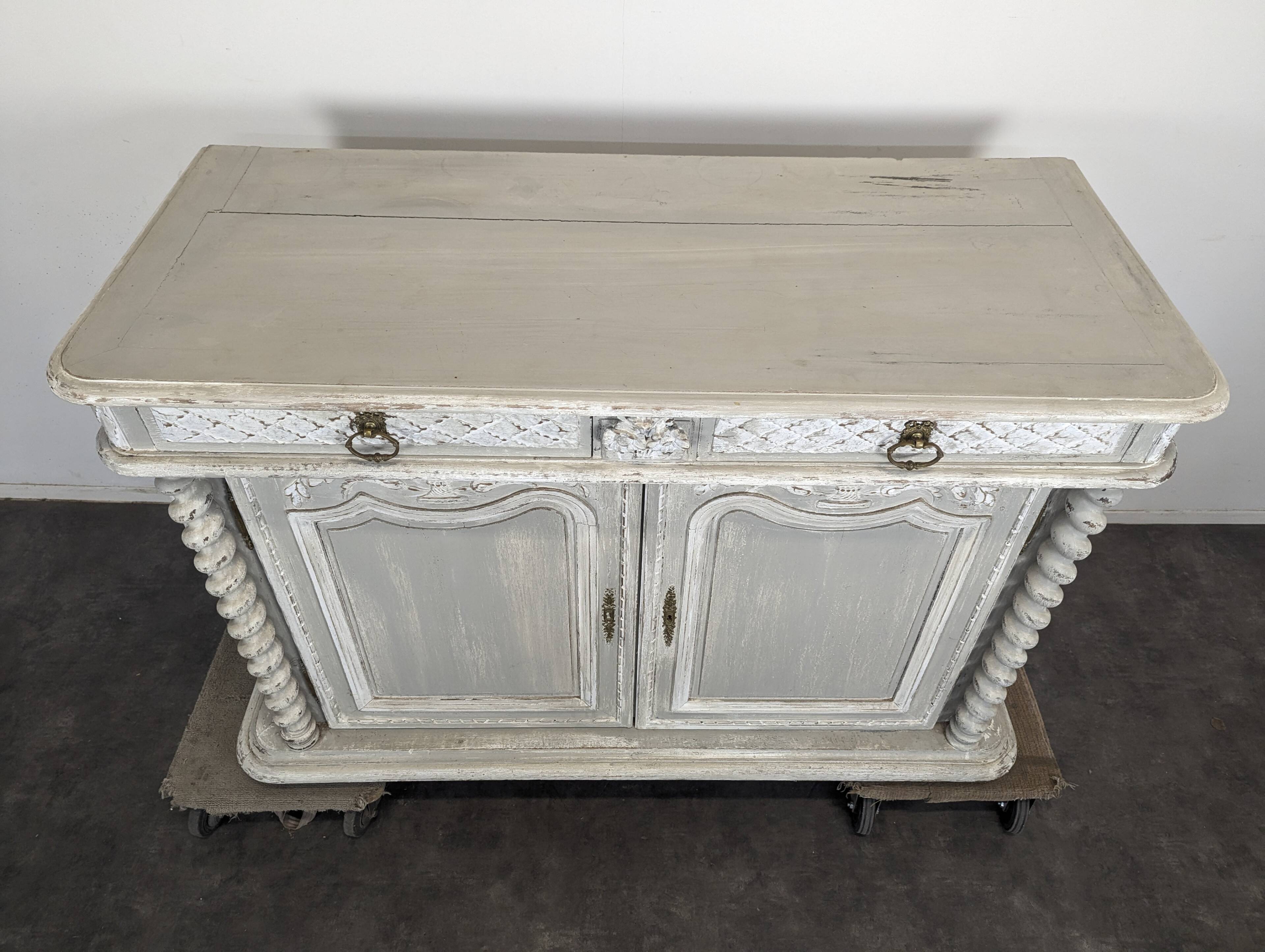 Louis XIII buffet with twisted column in grey patinated oak, two doors, two drawers.