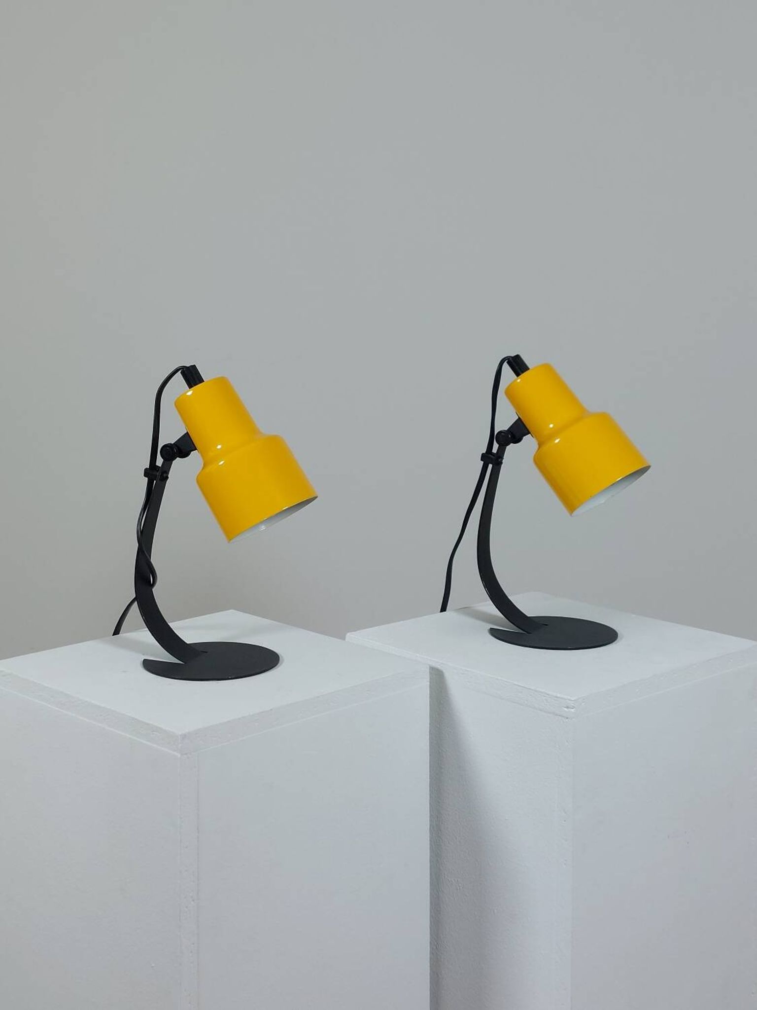 A pair of well-designed minimalist bedside lamps.