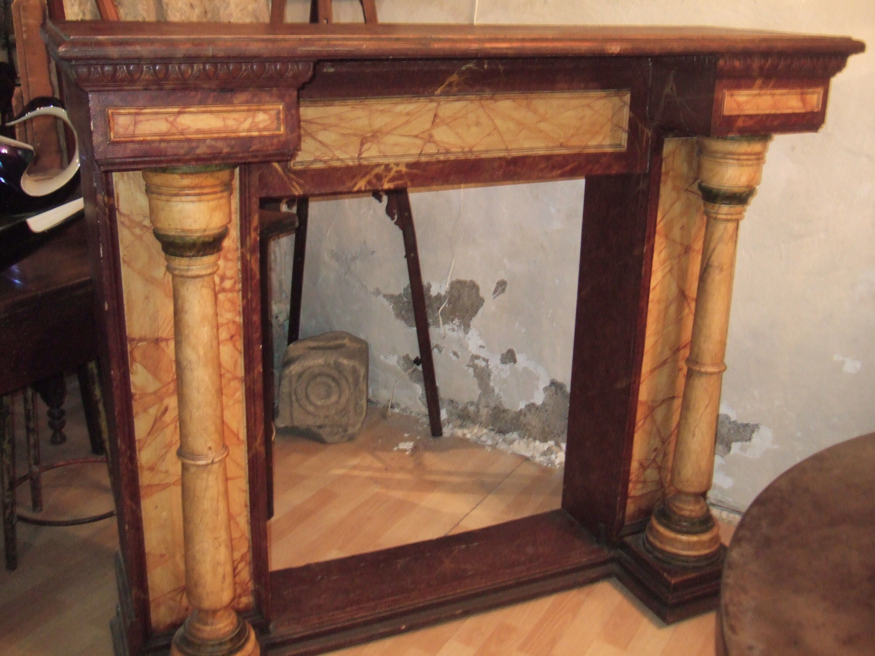 19th century wooden fireplace, faux marble paint. Can act as a console.