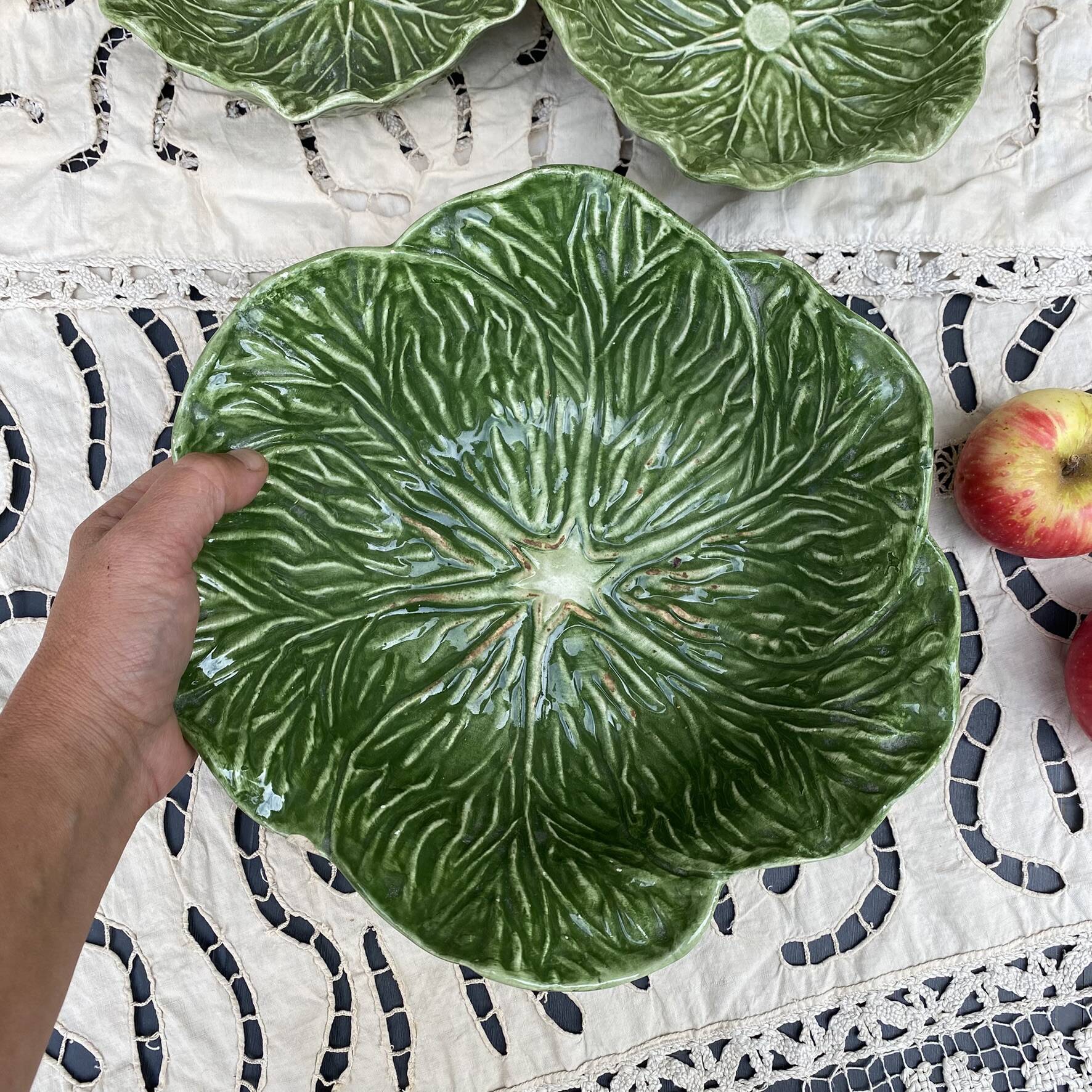 Large earthenware salad bowl in the shape of a cabbage leaf.