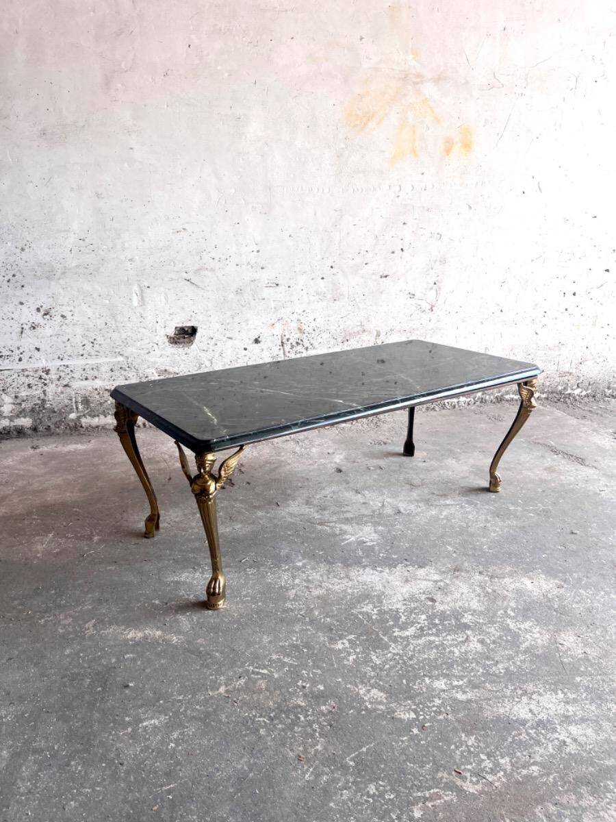 Vintage coffee table with a green marble top and gold legs.