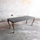 Vintage coffee table with a green marble top and gold legs.