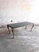 Vintage coffee table with a green marble top and gold legs.