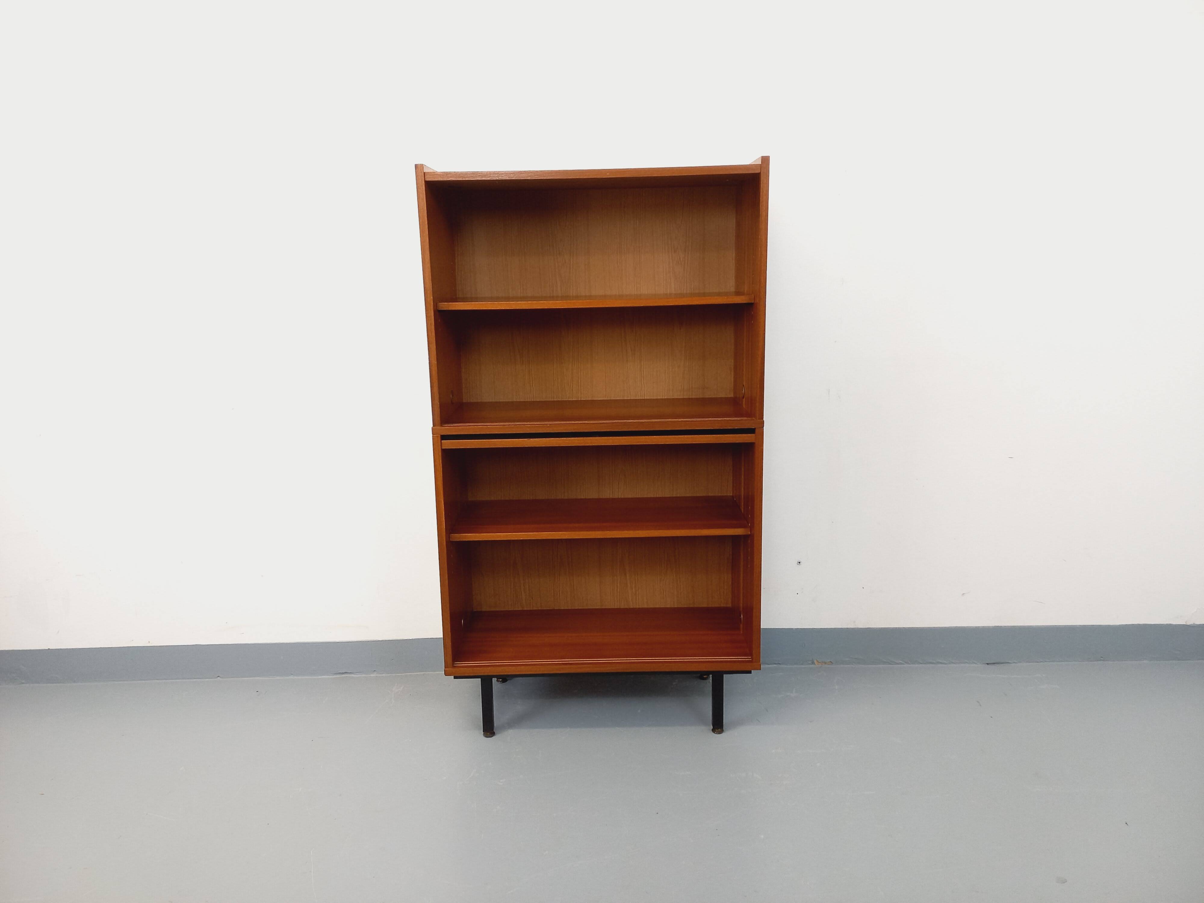 Vintage wooden bookshelf in teak style from the 1960s.