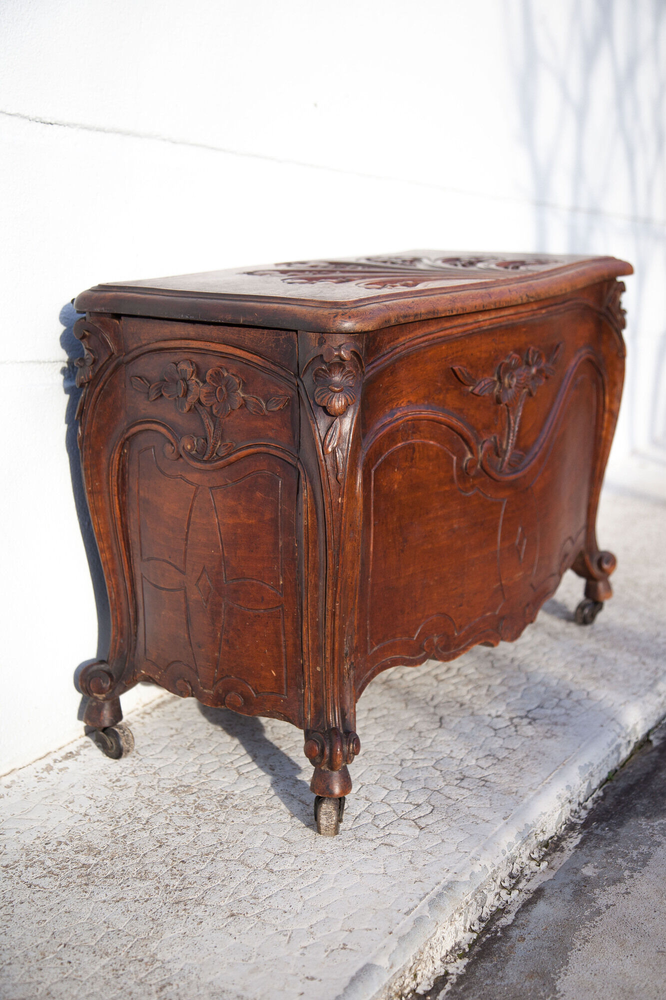 Old chest, carved wooden chest, curved chest on wheels, interior decoration