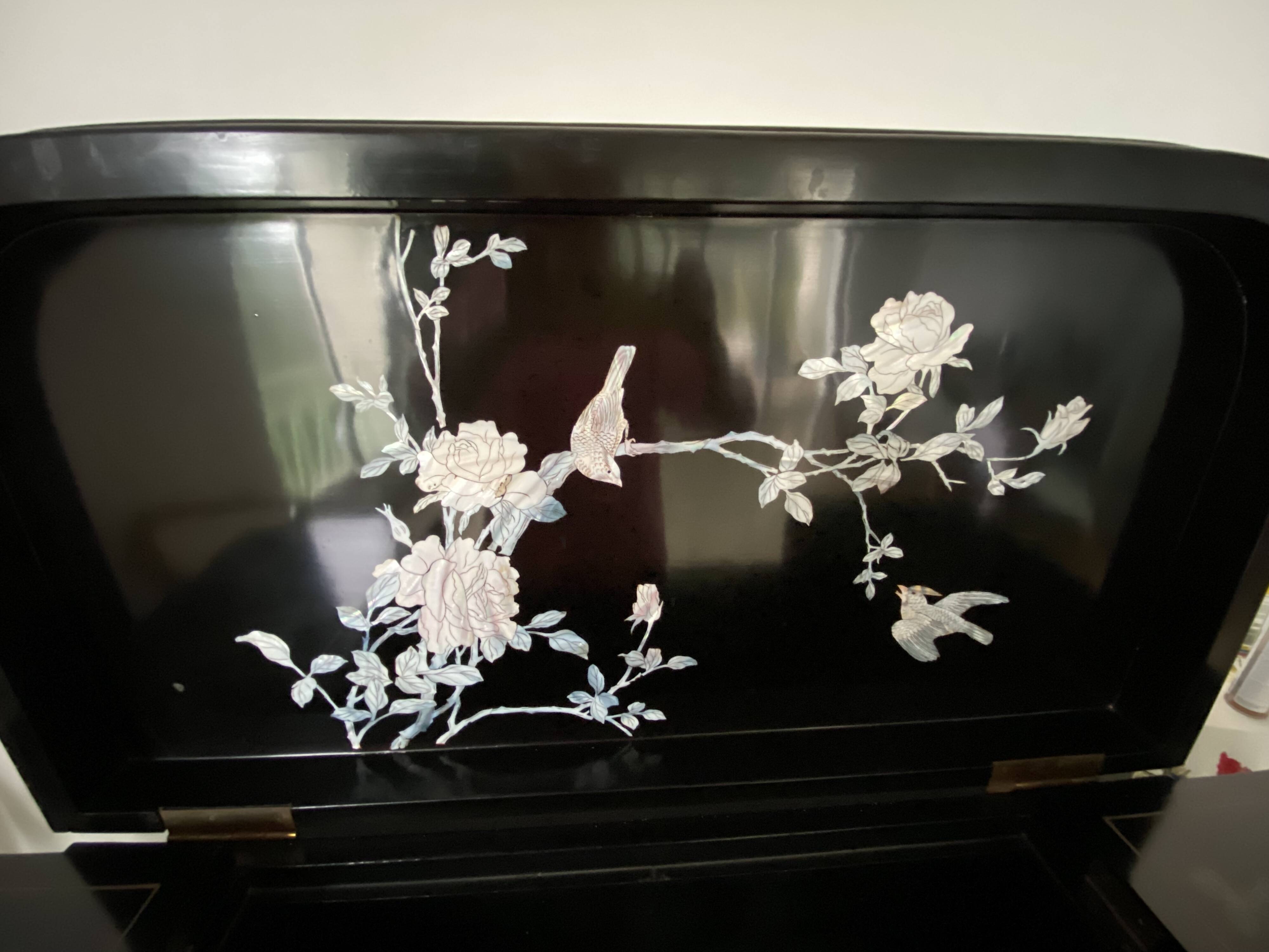 Black lacquered artisanal bar with mother-of-pearl inlays.