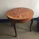 Round marquetry coffee table with curved legs in Louis XV style.