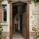 Old solid oak front door with frame and transom from the 19th century.