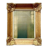 Old wall frame in carved gilded wood