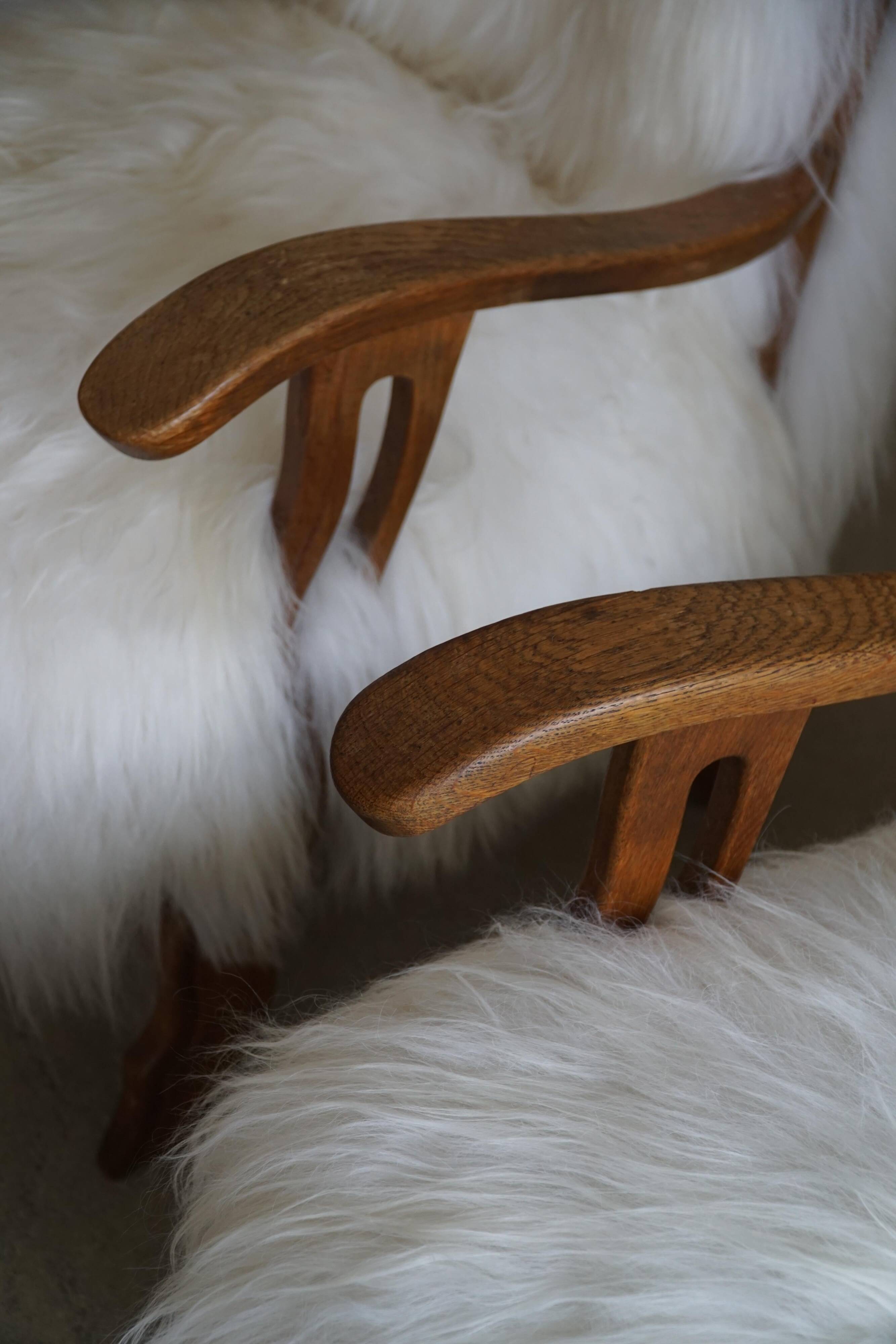 Pair of Scandinavian armchairs in oak and long-haired Icelandic sheepskin by Henning Kjærnulf, 1950.