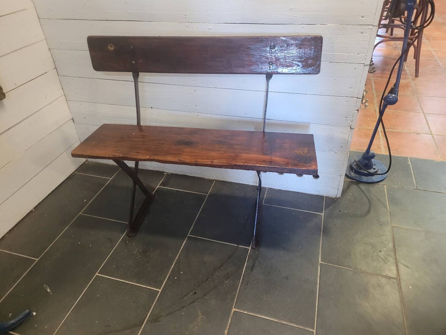 Old garden bench with iron legs and wooden seats