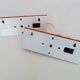 Pair of Scandinavian wall sconces with swivel shade in orange metal. 70