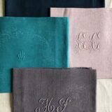 Set of four old damasked and monogrammed napkins, dyed in multiple colors