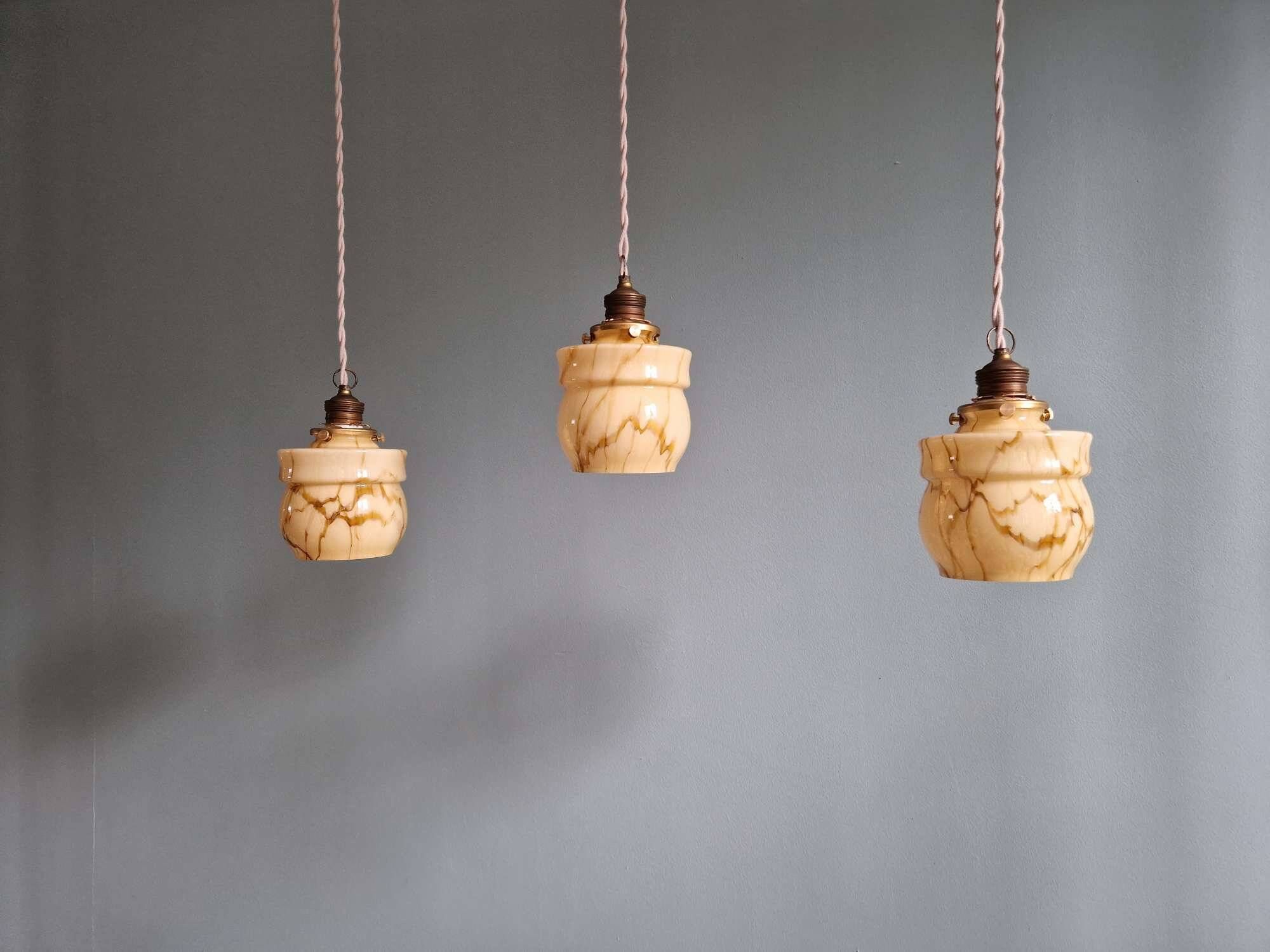 Art Deco trio of suspensions in opaline and marbled ouraline, Scailmont, 1920-30.