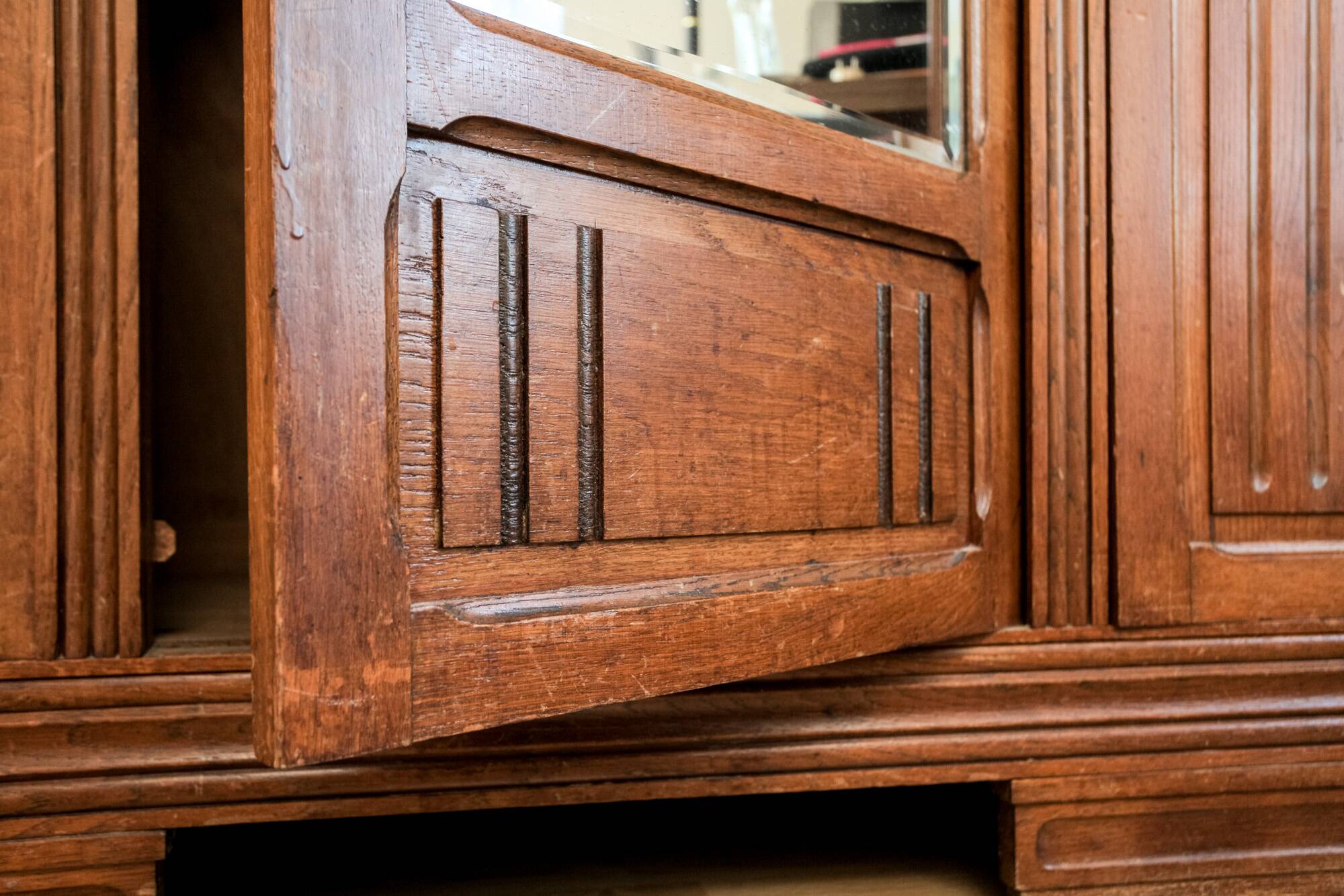 Old solid wood wardrobe with three vintage mirror doors