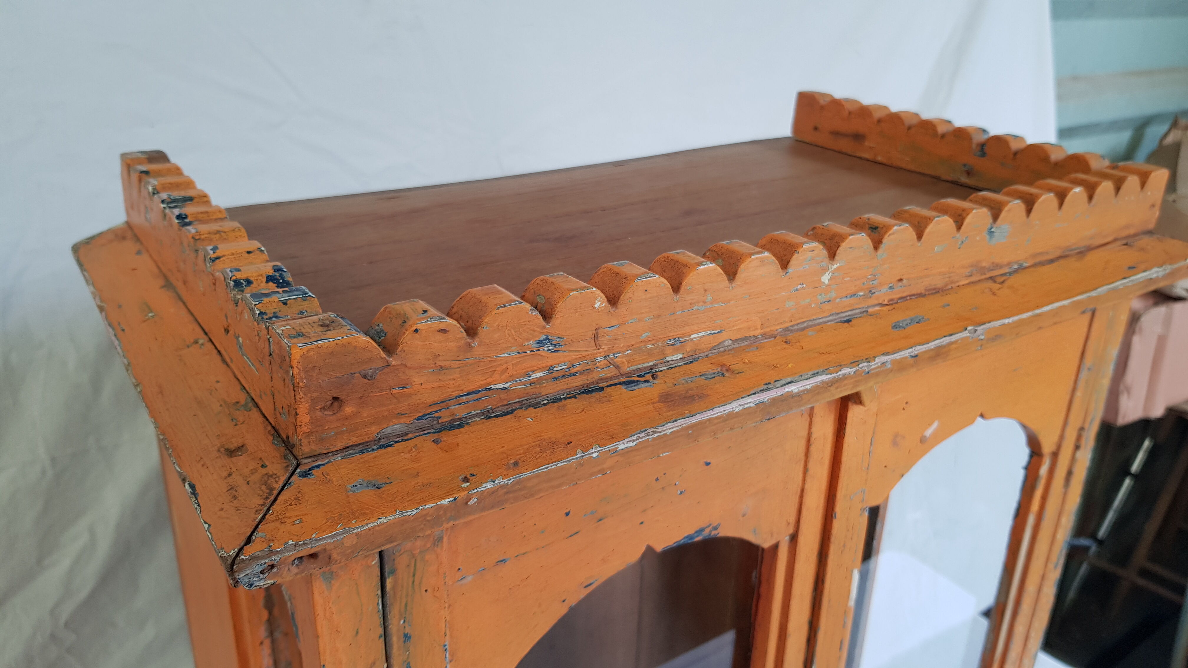Old temple-showcase with teak offerings
