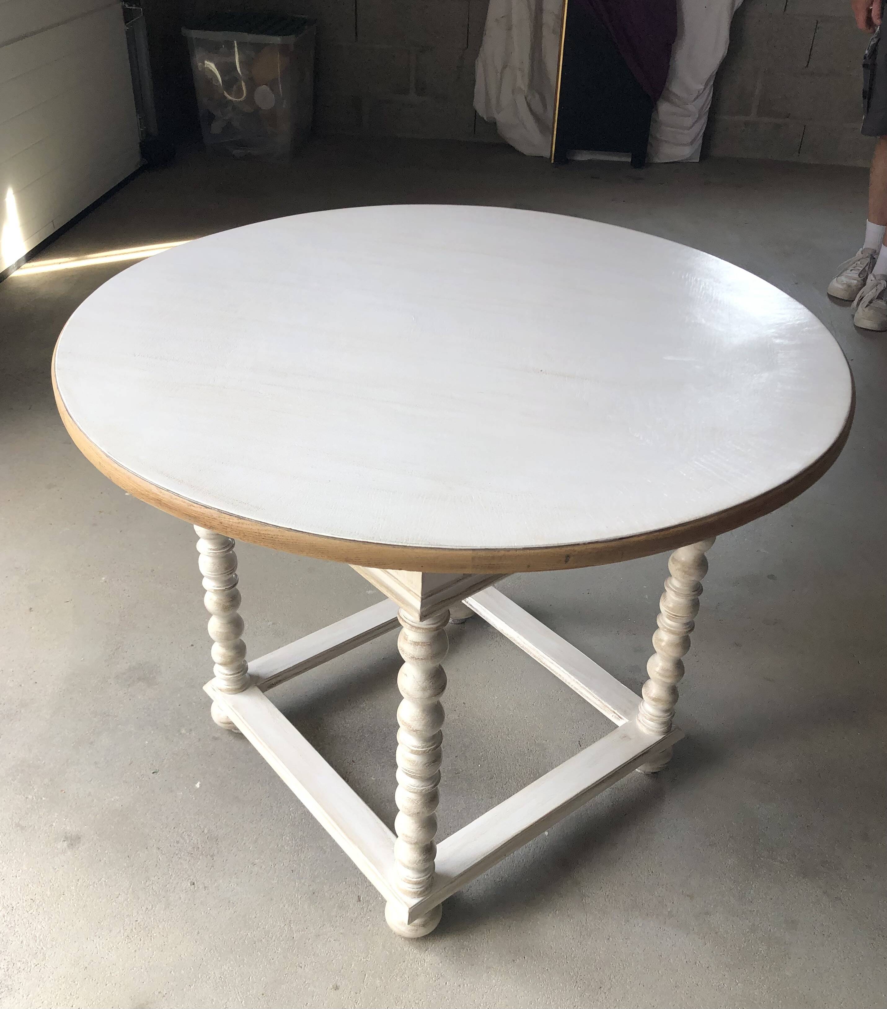 Antique round table refurbished in cerused white, with twisted legs.