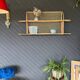 Steel and wicker wall shelf