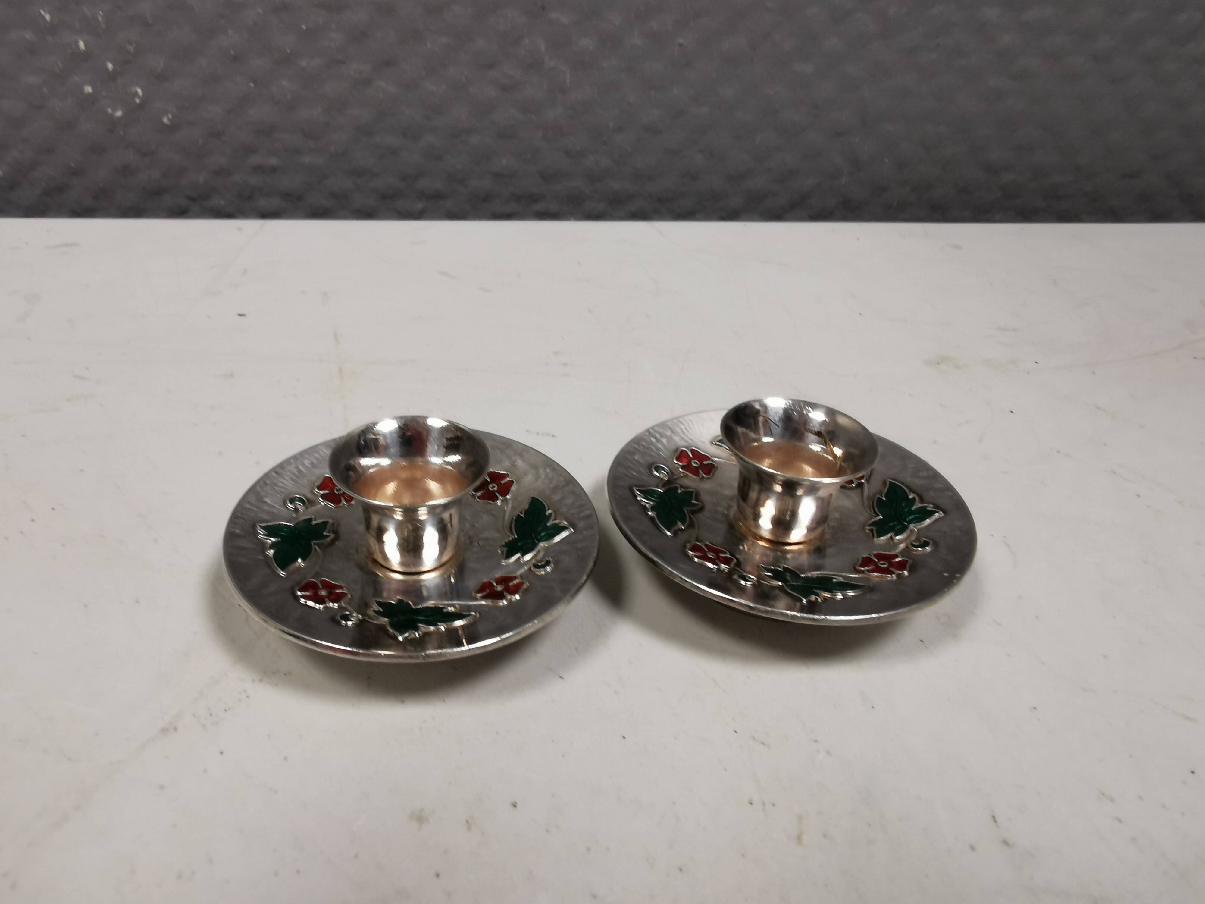 Silver-plated candle holders with inlaid red and green enamel