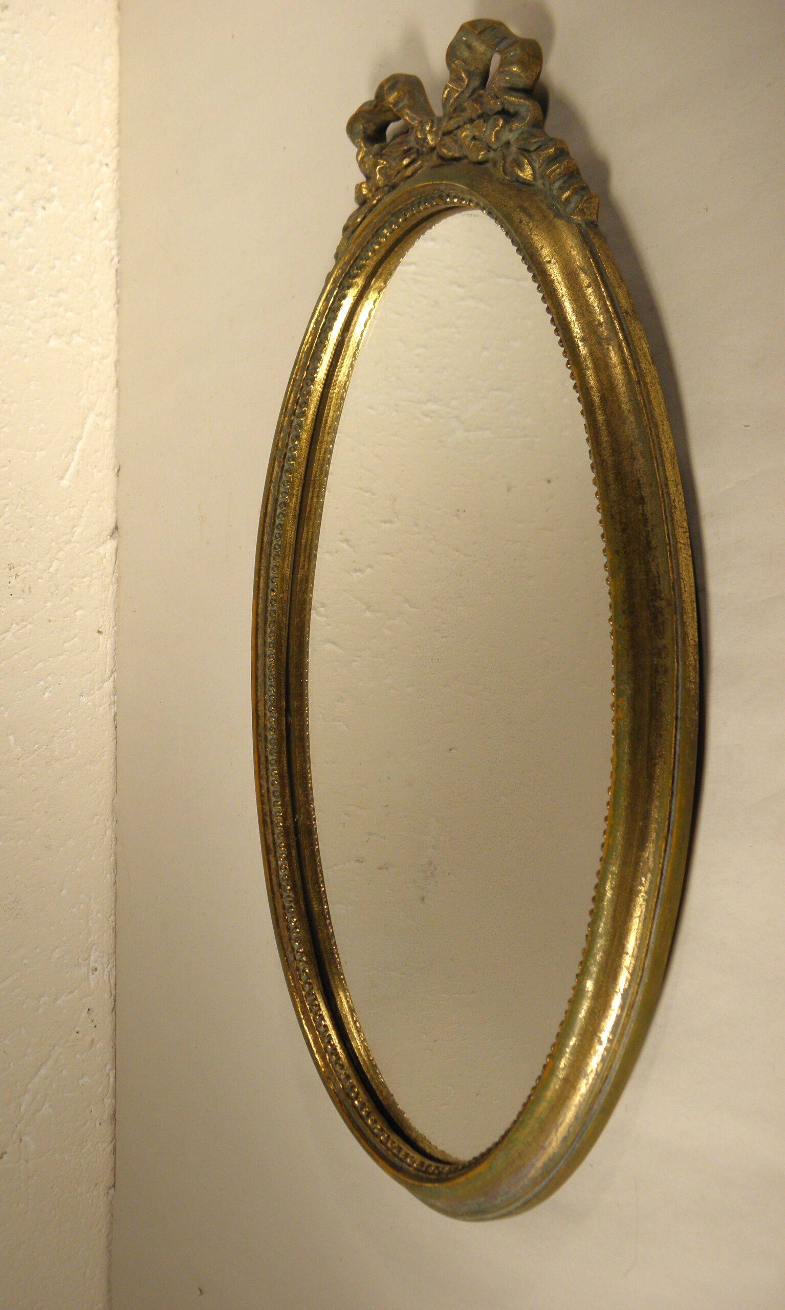 Golden oval mirror