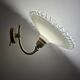 Wall sconces with scalloped opaline lampshades.