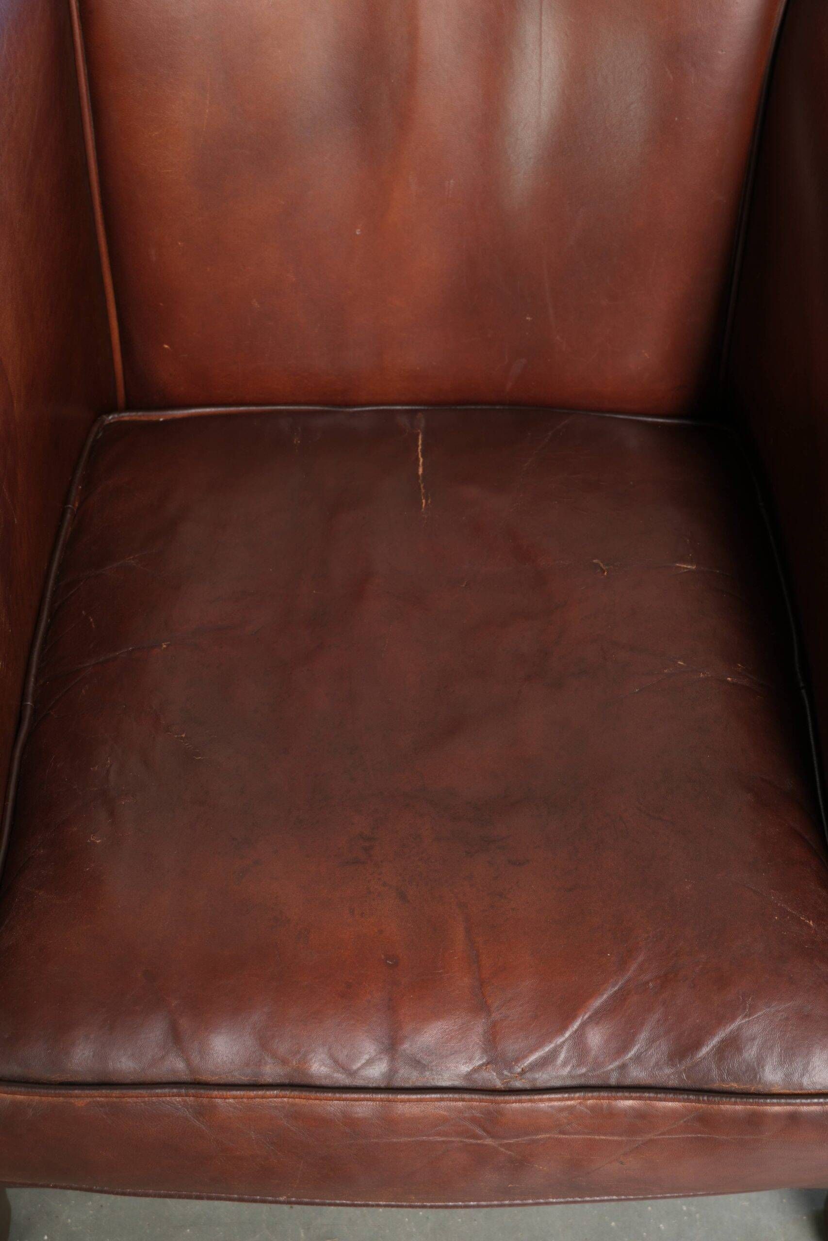 Sheepskin club armchair in English style with brown colour scheme