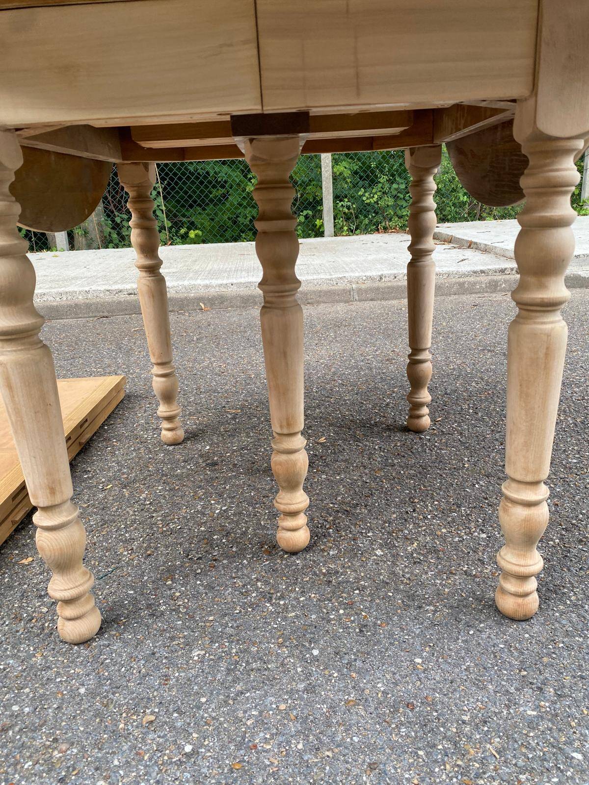 Round dining table with extendable leaves, Louis Philippe style, stripped in raw oak.
