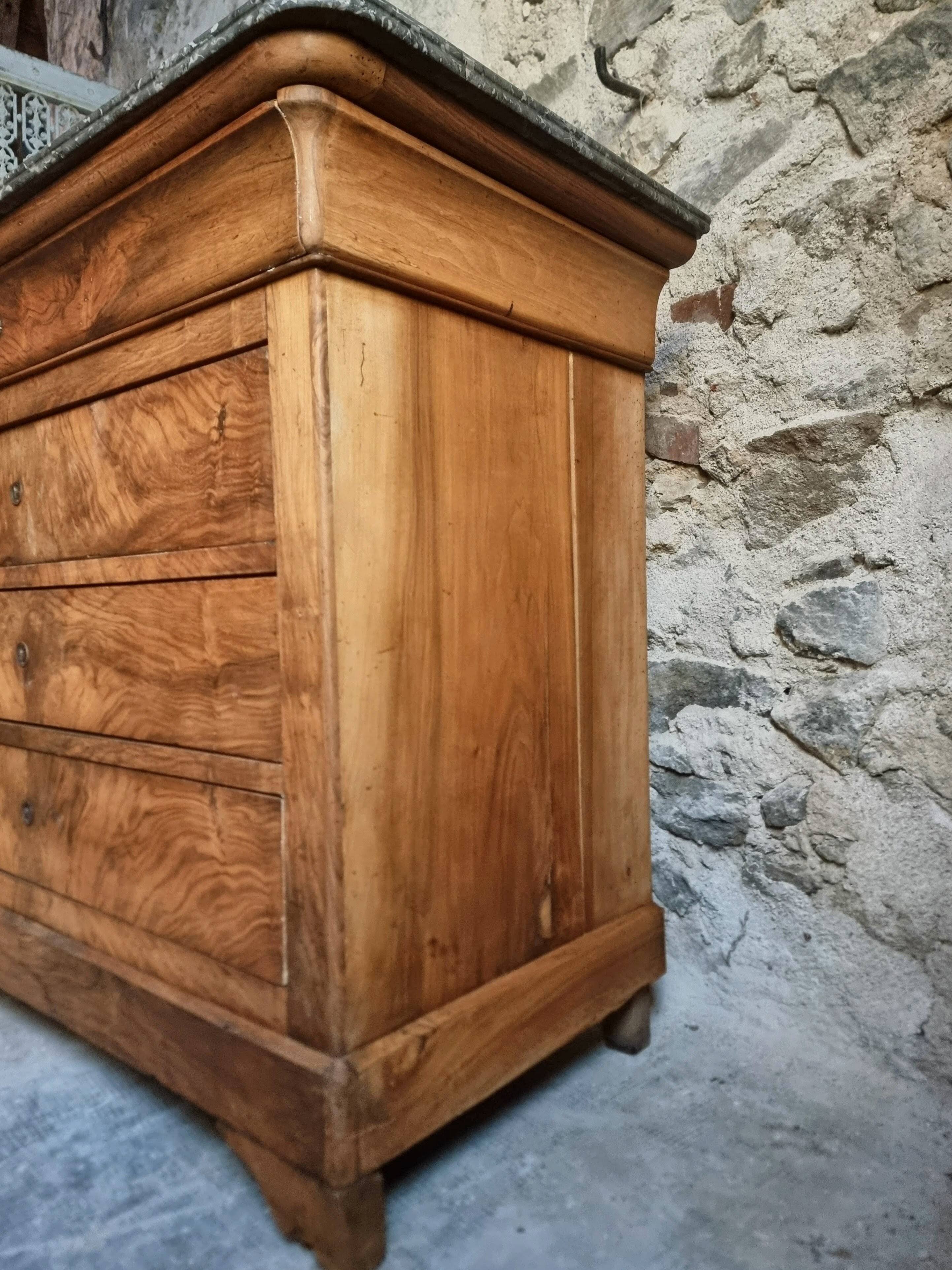 French antique walnut commode with a dark grey marble top, circa 1830–1860.