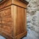 French antique walnut commode with a dark grey marble top, circa 1830–1860.