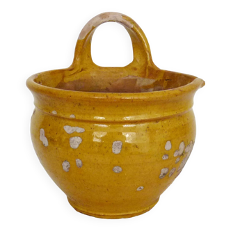 Old yellow glazed terracotta pot. Popular art, peasant art. 1920s