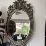 Beveled oval mirror in wood and stucco