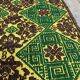 Green and yellow handmade rug with delicate colourful flowers