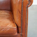 Cognac-colored cow leather club chair finished with decorative nails in English style