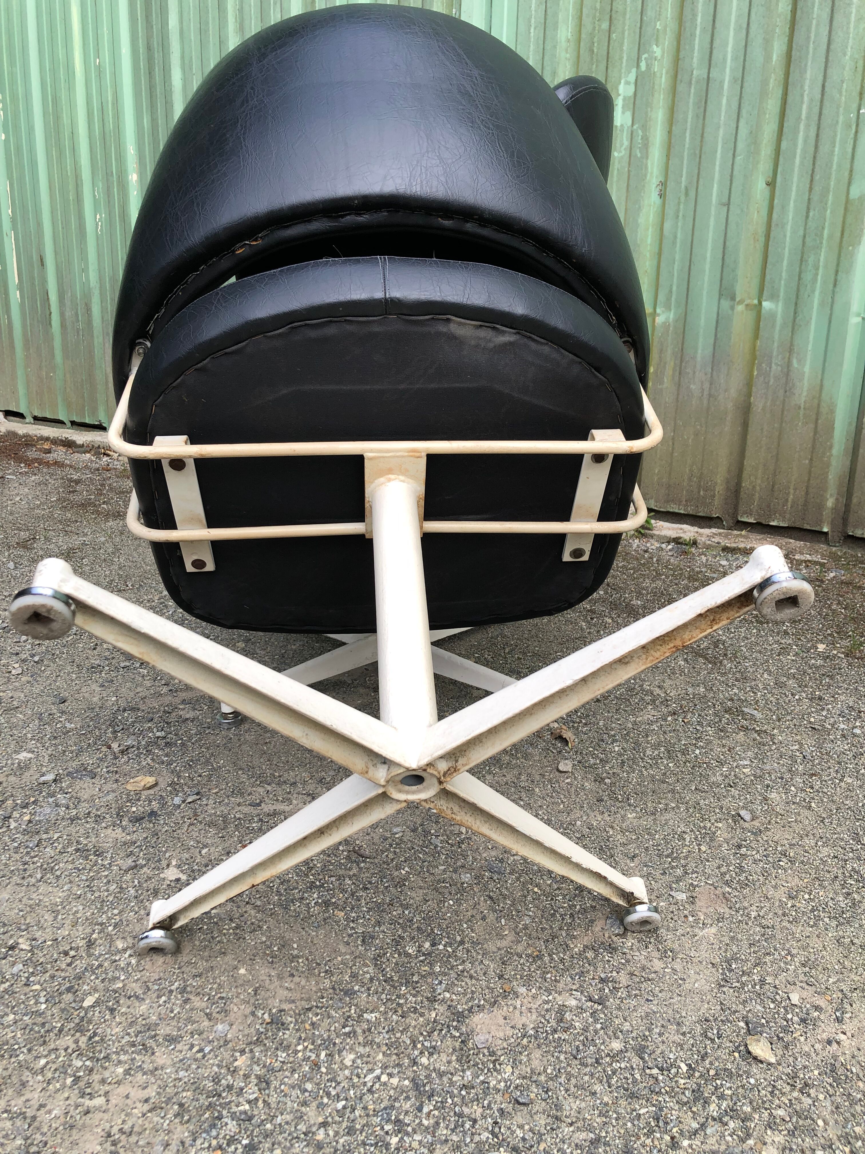 Pair of vintage armchairs in black skai with metal legs.