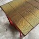 Vintage terracotta-red metal side table with glazed brown-green ceramic tile surfaces