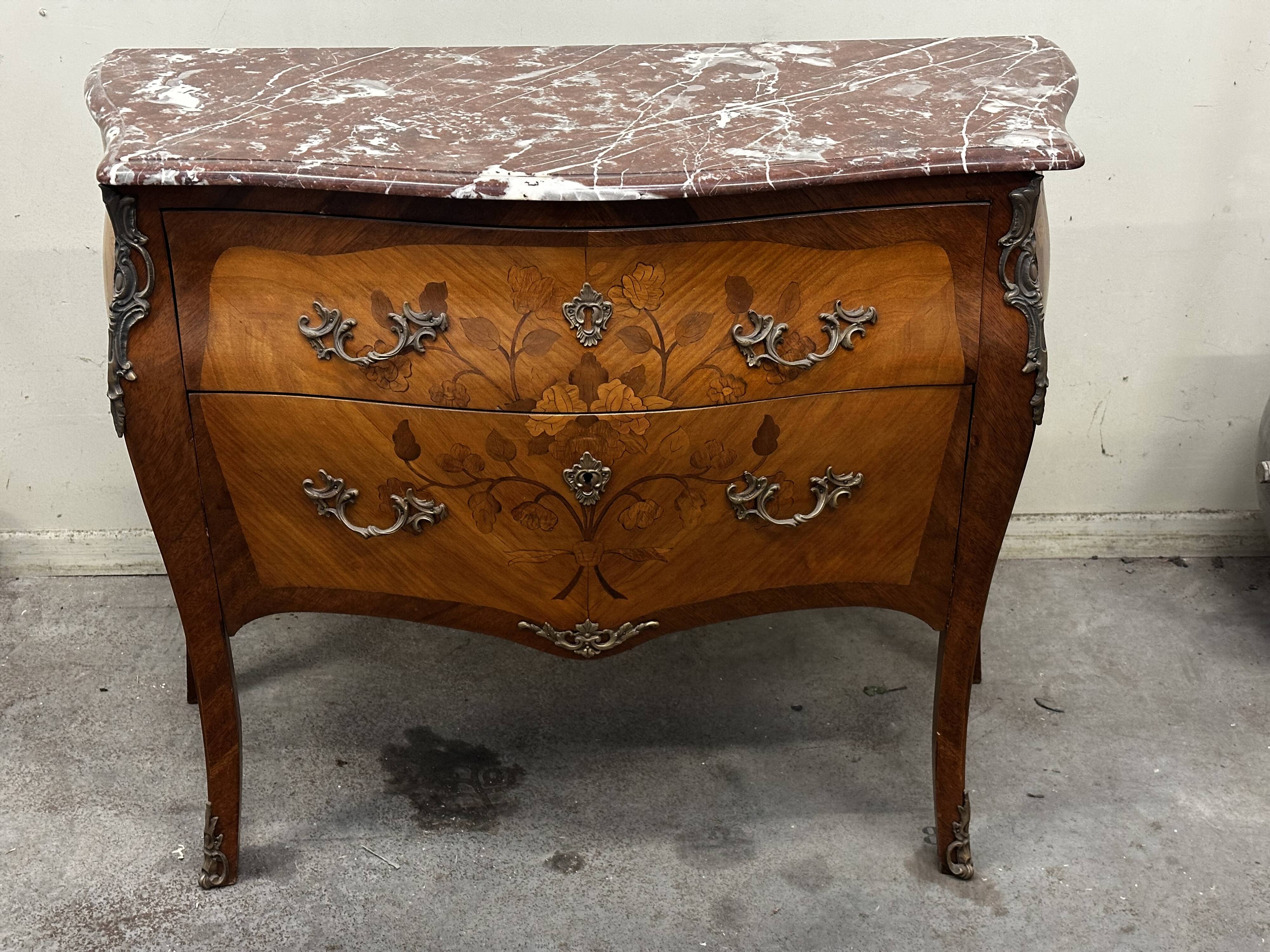 Curved and inlaid Louis XV style chest of drawers