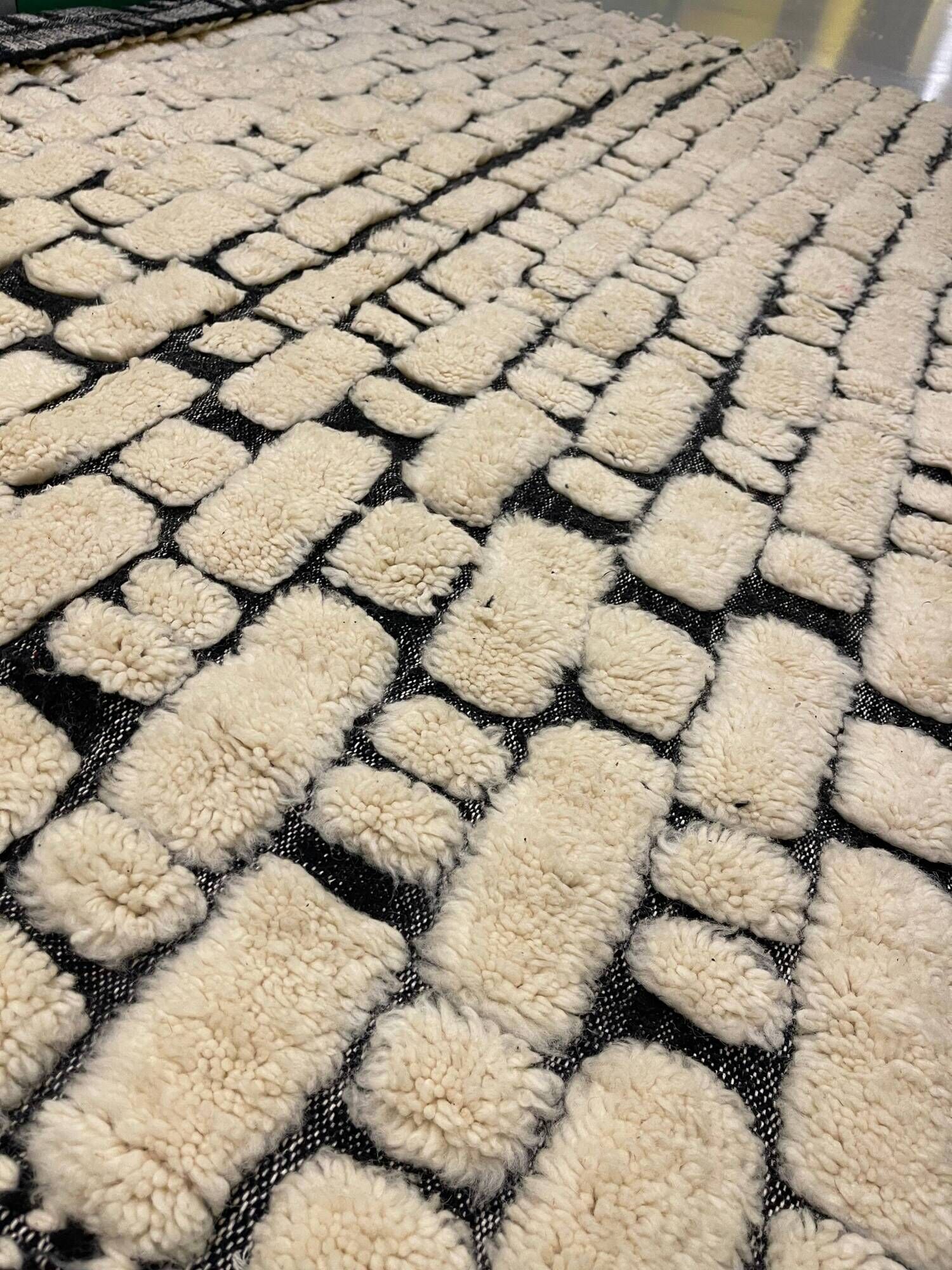Large cream and black checked Berber rug, 280 × 200 cm.
