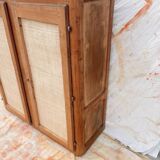 Low cabinet in raw wood and woven raffia