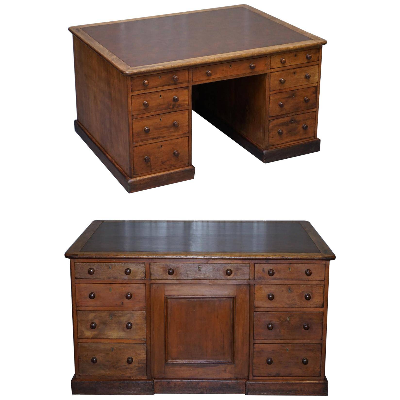 Antique Victorian oak kneehole desk with 18 double-sided drawers.