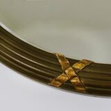 Faceted wall mirror in neoclassical Gustavian style, oval, in gilded wood, Italy, 1900s.