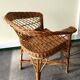 Woven rattan armchair with armrests.