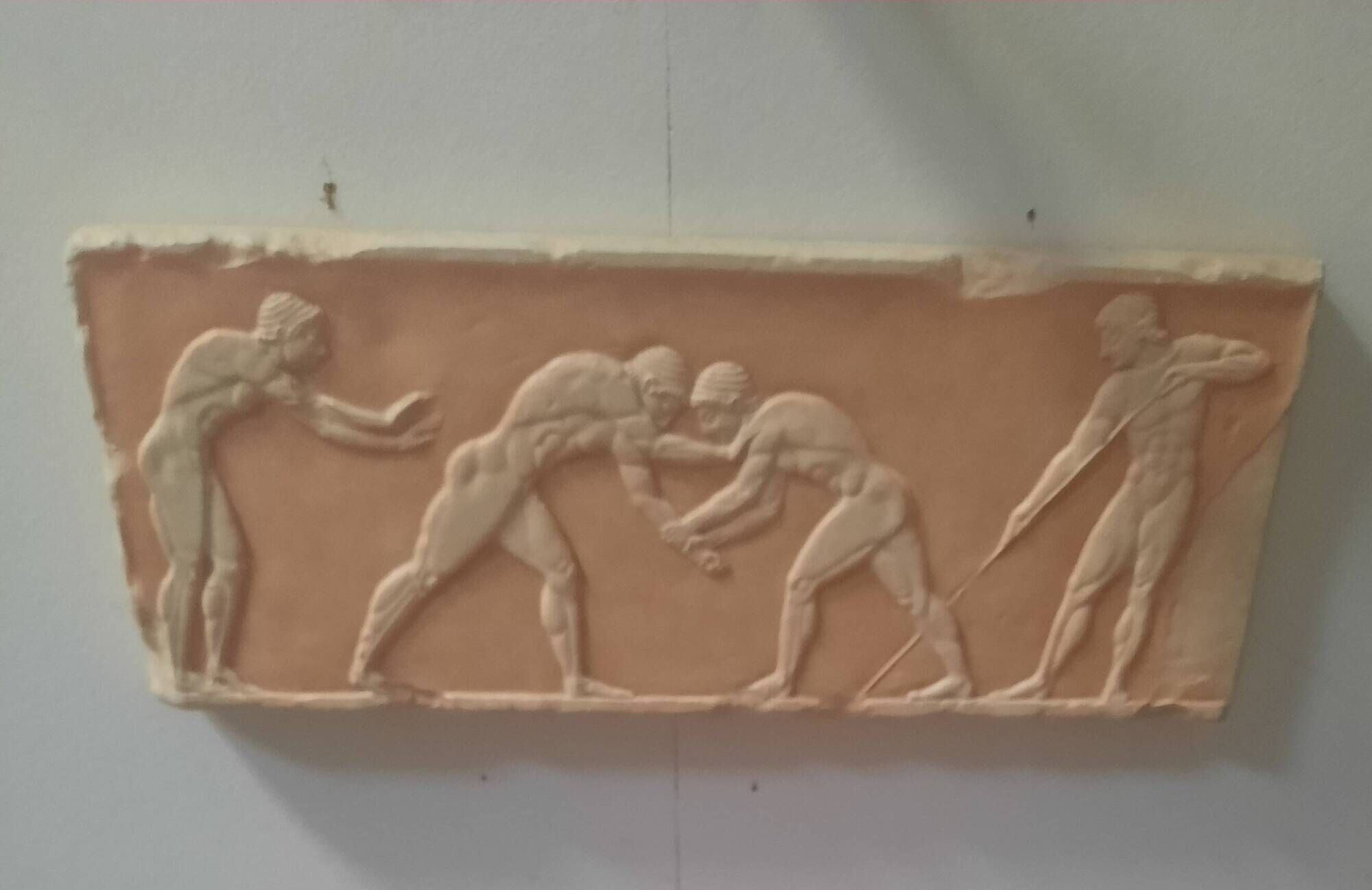 Bas-relief in the antique style featuring athletes.