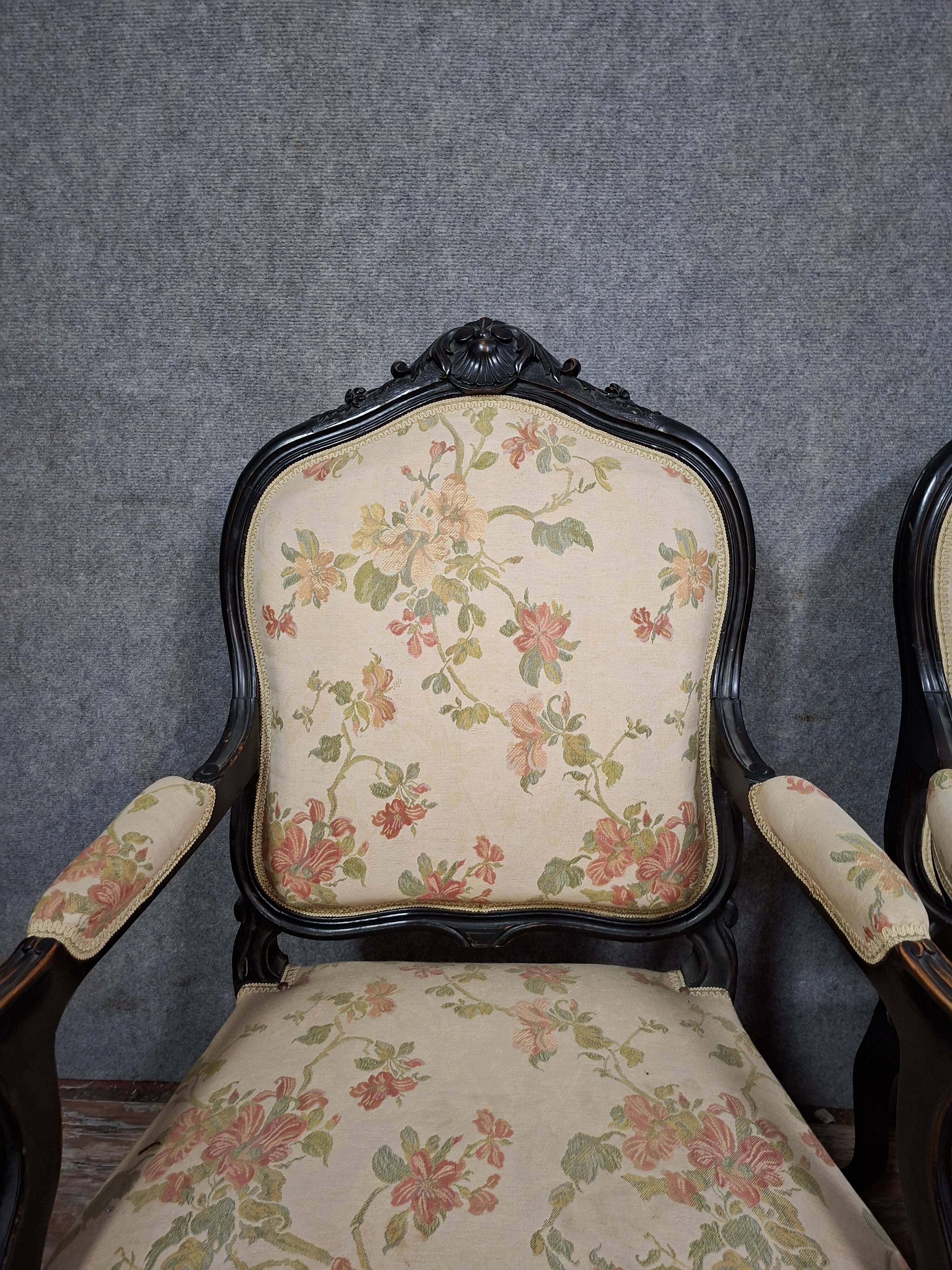 pair of Louis XV style armchairs, in moulded and carved wood, lacquered black