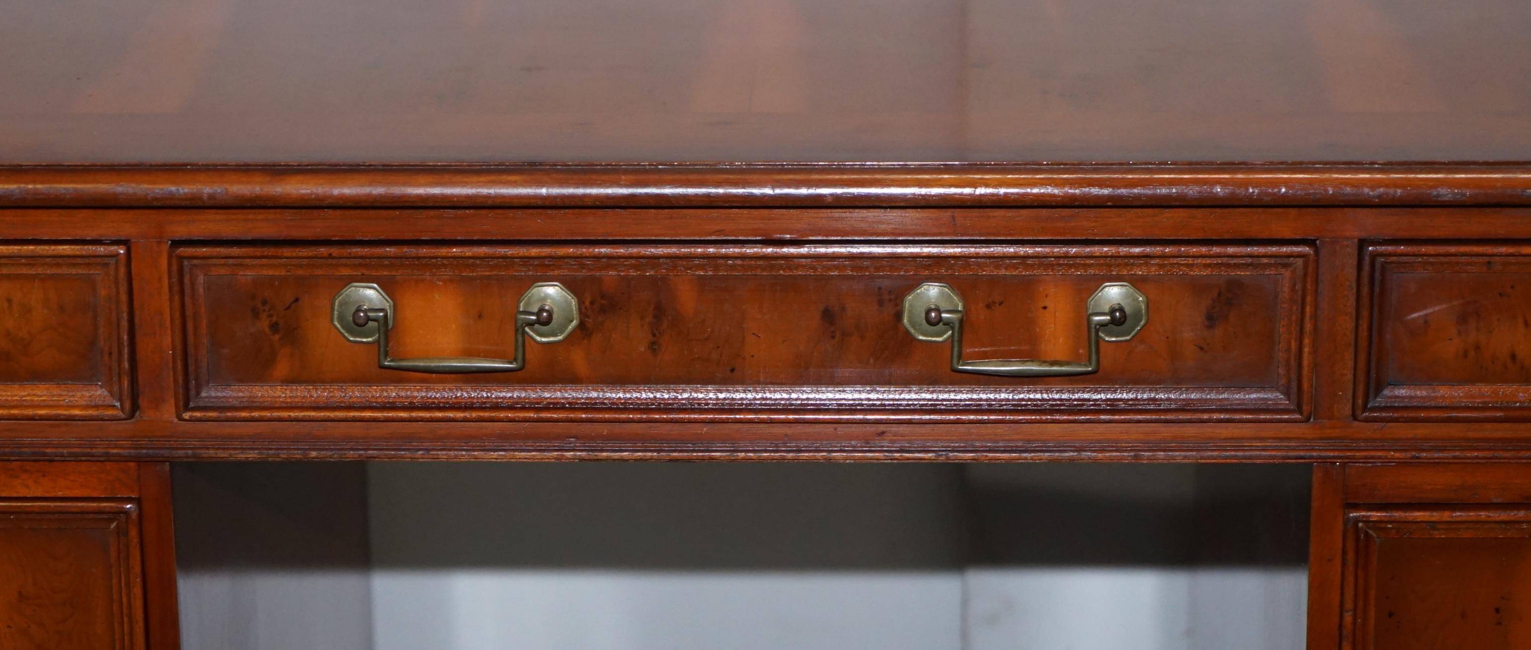 Partner desk with double pedestal in burr yew wood with decorated top.