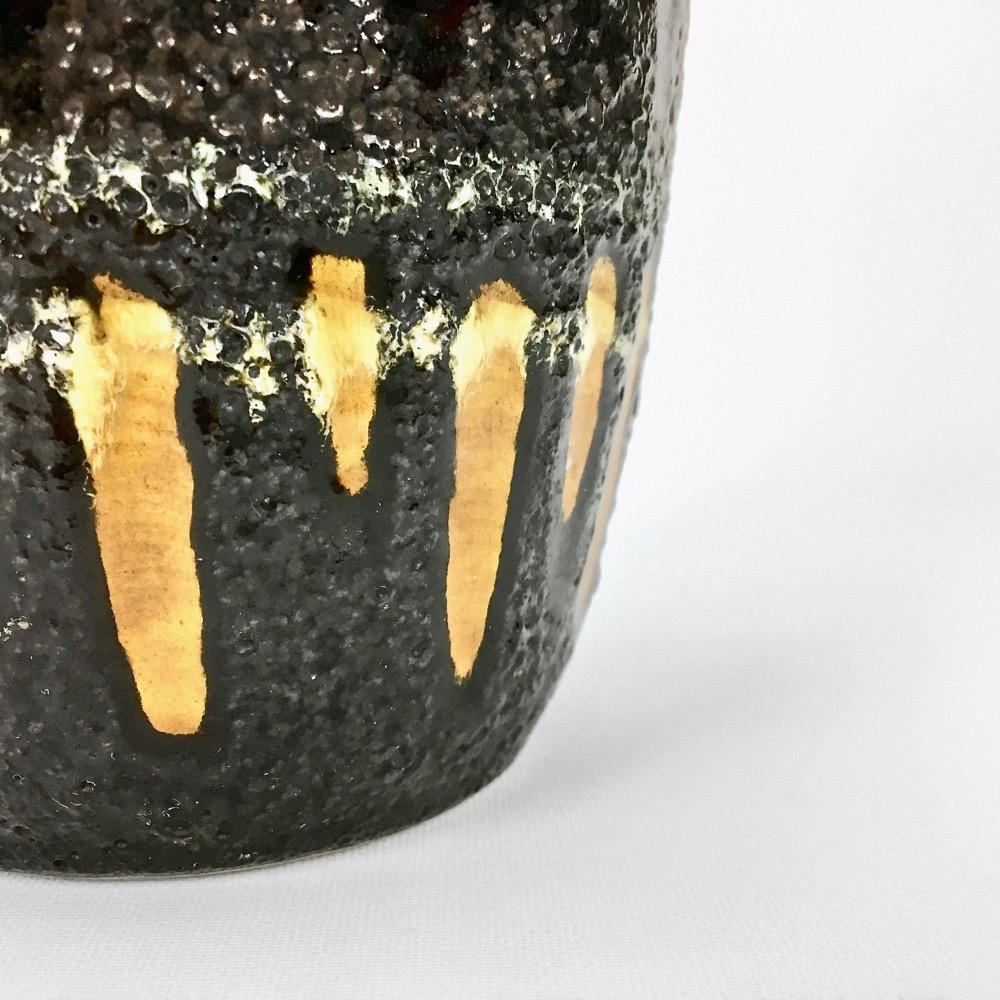 "Fat Lava" vase black background and colorful enamelled drippings