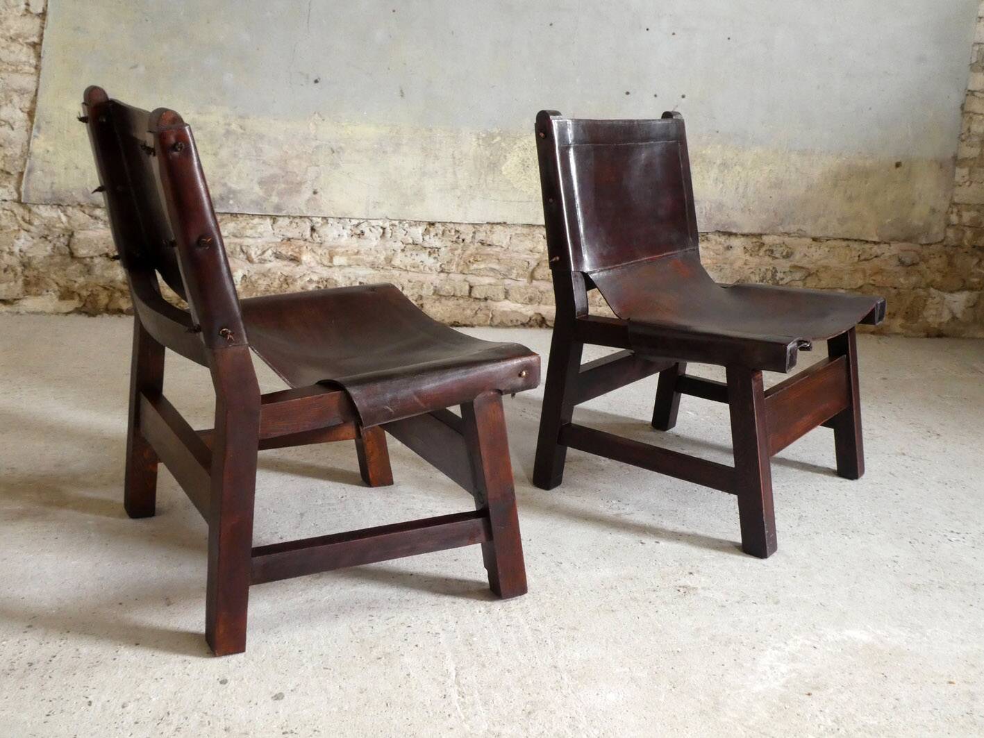 Pair of brutalist armchairs in wood and leather, 1970