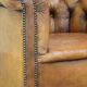 Antique, characteristic sheepskin chesterfield club chair on wheels