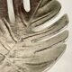 Leaf-shaped metal pocket emptier
