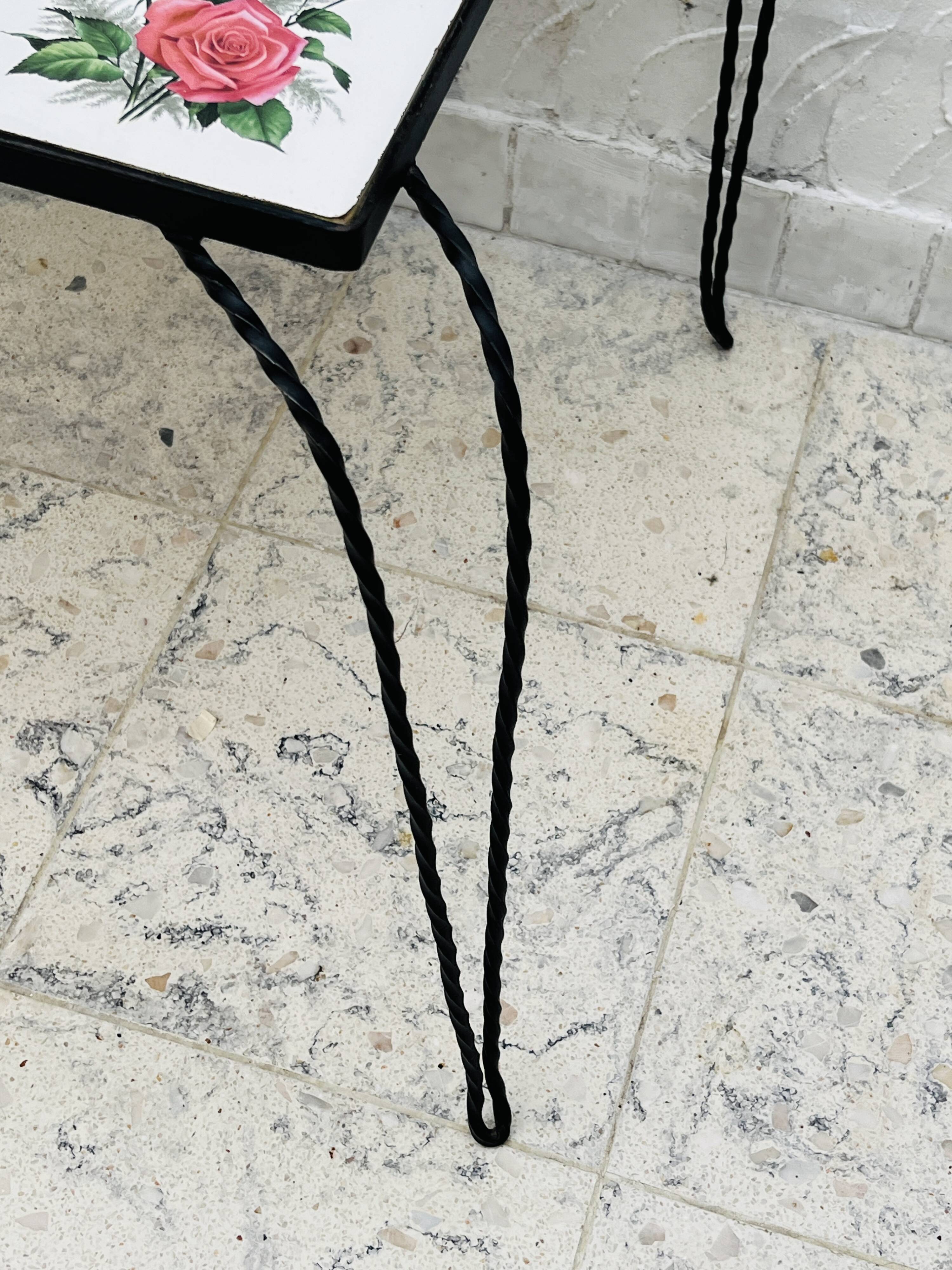 Vintage coffee table in wrought iron with floral tiles.