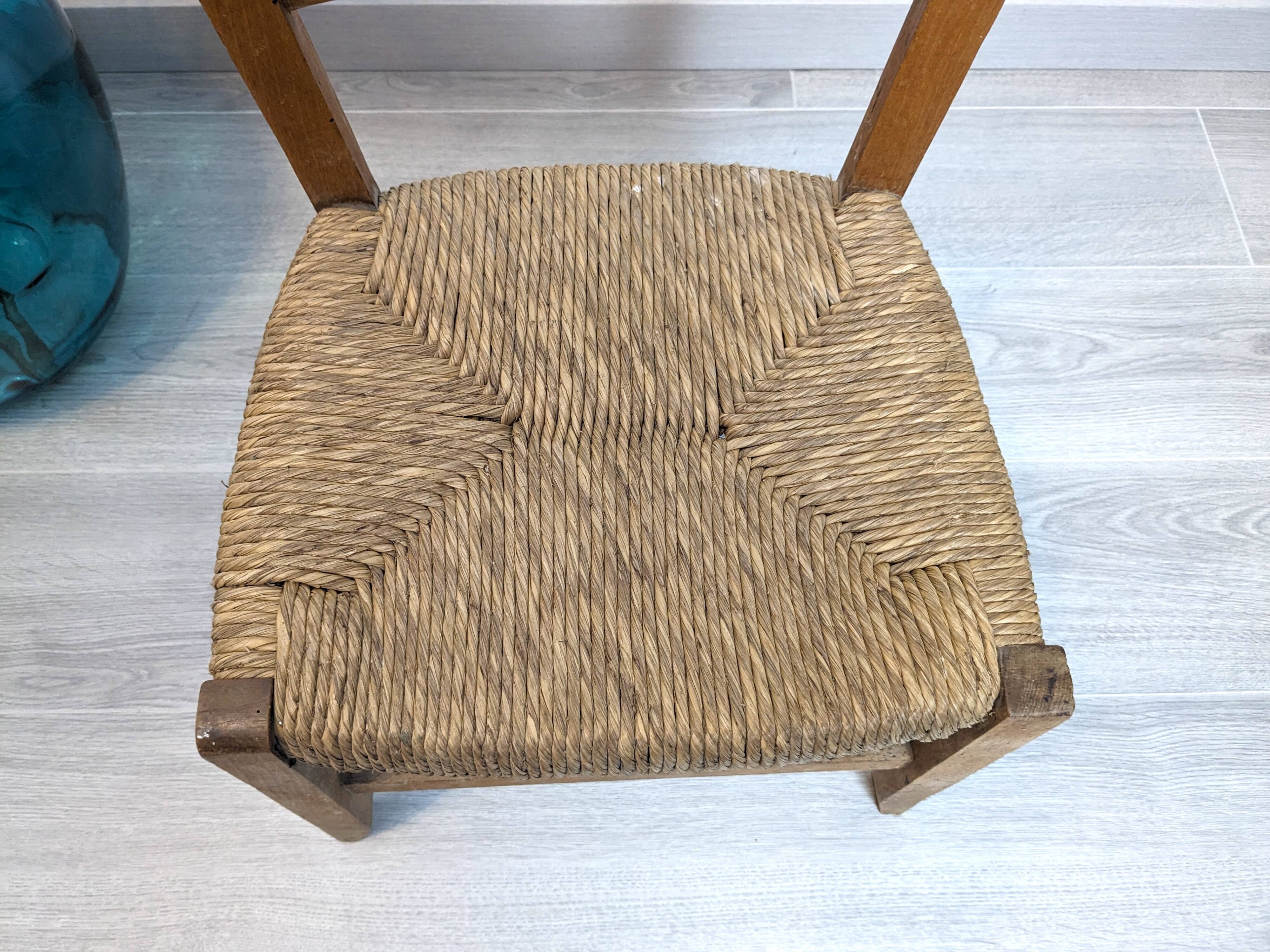 Vintage wooden and straw children's chair in a country style.